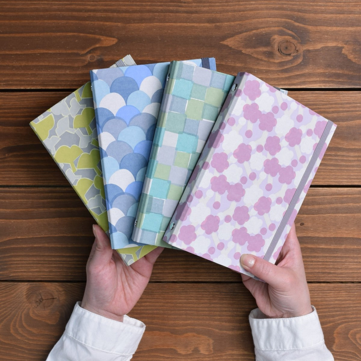 Personal size planner binders held in hands